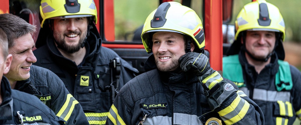 Feuerwehrleute in Einsatzkleidung bei einer Besprechung